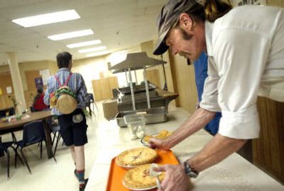 
Shalom Ministries cook Robert Tidd brings pies out of the kitchen during lunch Tuesday in the basement of Central United Methodist Church. 
 (Holly Pickett / The Spokesman-Review)