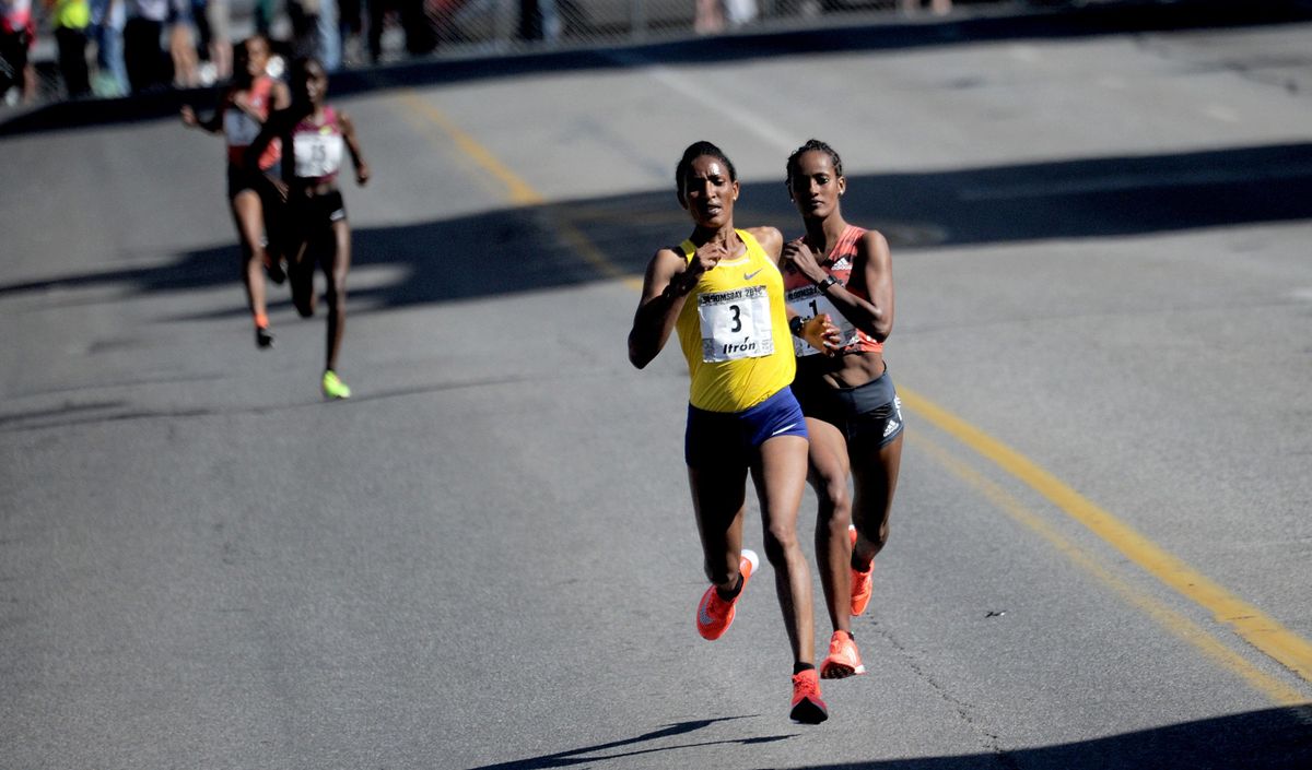 Buze Diriba, right, and Mimitu Daska, left, battle it out near the finish line during the women’s elite race at the 2018 Lilac Bloomsday  races on Sunday. (Kathy Plonka / The Spokesman-Review)