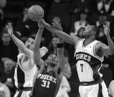 
Seattle's Nick Collison, left, and Rashard Lewis battle Phoenix's Shawn Marion for a rebound. 
 (Associated Press / The Spokesman-Review)