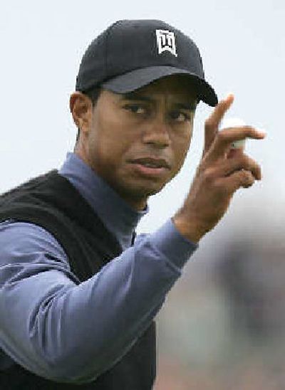 
Tiger Woods is pleased with a birdie on the 11th during the first round of the British Open. 
 (Associated Press / The Spokesman-Review)