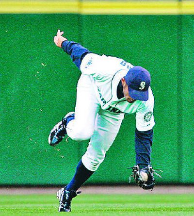 
Seattle Mariners center fielder Ichiro Suzuki makes a catch on the run. 
 (Associated Press / The Spokesman-Review)