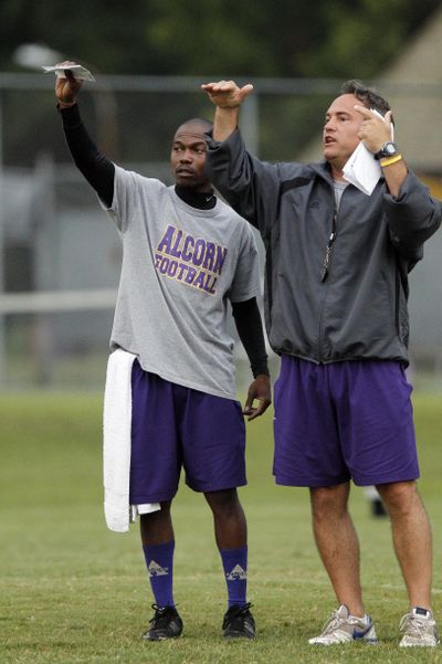 Alcorn State football coach Jay Hopson talks with head equipment manager Anderson Dye. (Associated Press)