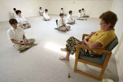
 Maharishi School of the Age of Enlightenment students practice Transcendental Meditation in front of TM teacher Siggi Lamothe, right, in Fairfield, Iowa. 
 (Aassociated Press / The Spokesman-Review)