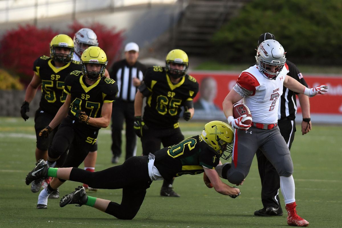 After gaining a first down, Ferris running back Jonny Via (7) is tripped up by Shadle Park line backer Brock Leinweber (26) during the first half of a GSL high school football game at Joe Albi Stadium, Friday, Sept. 30, 2016, in Spokane, Wash. (Colin Mulvany / The Spokesman-Review)