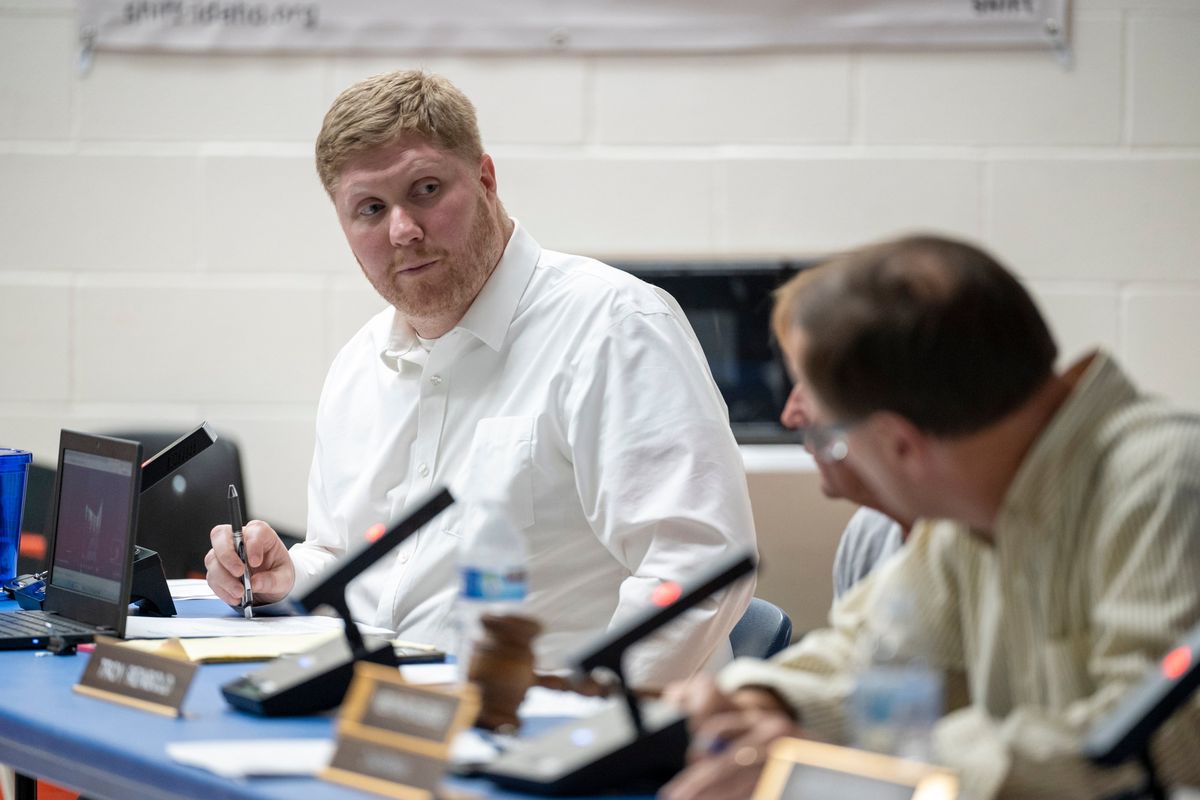 West Bonner County Superintendent Branden Durst, left, at a board meeting in the Priest River Lamanna High School cafeteria on July 26.  (Jesse Tinsley/The Spokesman-Review)