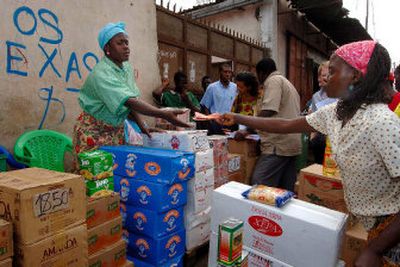 
Ana Helena Domingos, an Angolan wholesaler, gives a customer  change in Luanda. Domingos used a $1,000 loan to double her income in 10 months. Her loan came from a microcredit bank modeled on the one that won the Nobel Peace Prize on Friday. 
 (Associated Press / The Spokesman-Review)