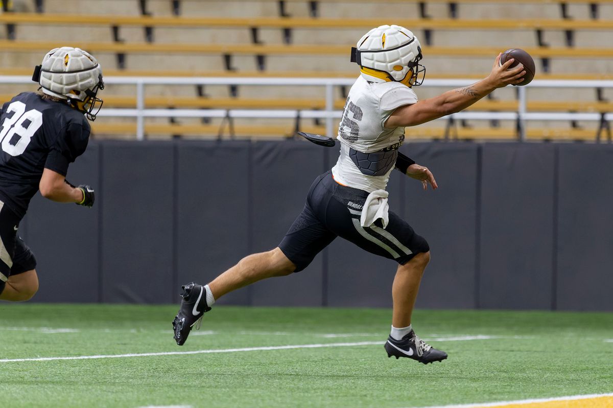 Idaho freshman quarterback Rocco Koch, right, slips past defensive back Ty Hirrlinger for a touchdown during a scrimmage on Saturday, Aug. 17, 2024, at the Kibbie Dome in Moscow, Idaho.  (Geoff Crimmins/The Spokesman-Review)