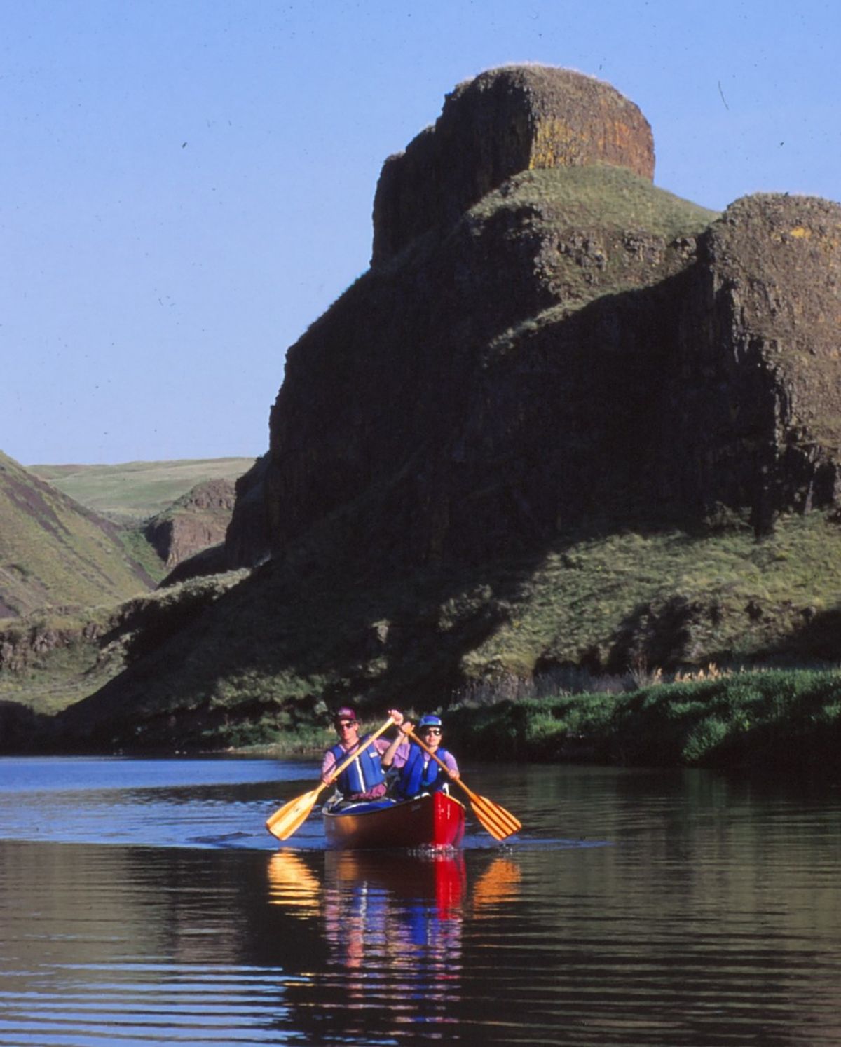 Jean and Kevin Dragon power the red canoe back down the slackwater of the lower Palouse River after they’d paddled upstream to the plunge pool below Palouse Falls for a 1995 guidebook research.  (Rich Landers/For The Spokesman-Review)