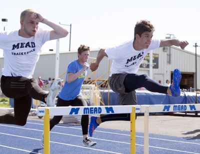 Mead athletes, from left, Thomas Dammarell, Pierce Christensen and Joseph Heitman work on their hurdles technique  in preparation for state competition. Heitman takes part in hurdles, relays and long jump. (Jesse Tinsley / The Spokesman-Review)