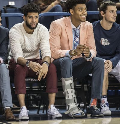 Josh Perkins and Jeremey Jones watch teammates on the floor against West Georgia, Saturday, Nov. 5, 2016, in the McCarthey Athletic Center. (Dan Pelle / The Spokesman-Review)