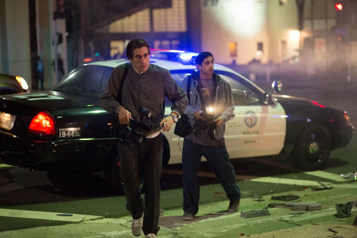 Jake Gyllenhaal, left, and Riz Ahmed appear in a scene from “Nightcrawler.” Gyllenhaal and Ahmed portray freelance videographers who document police and rescue activity for a Los Angeles news station.