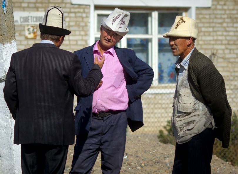 In a village near the Manas Transit Center in Kyrgyzstan, men gather to chat wearing their traditional 'kolpaks' (tall felt hats. (Colin Mulvany / The Spokesman-Review)