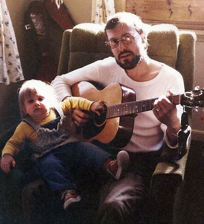 Ed Grim plays guitar with his daughter, Molly, in the late 1970s.