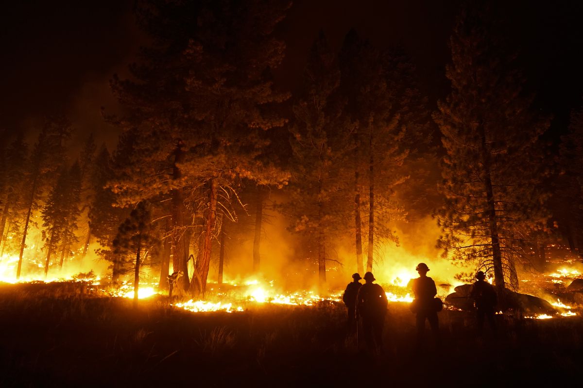 FILE - In this Wednesday, Sept. 1, 2021, file photo, a firefighter lights a backfire to stop the Caldor Fire from spreading near South Lake Tahoe, Calif. Thousands of wildfires burn in the U.S. each year, and each one requires firefighters to make quick decisions, often in difficult conditions like high winds and lightning. Crews and managers must determine when to bring in aircraft, what time of day is best to battle flames, whether to evacuate residents and even if certain fires should be extinguished at all.  (Jae C. Hong)