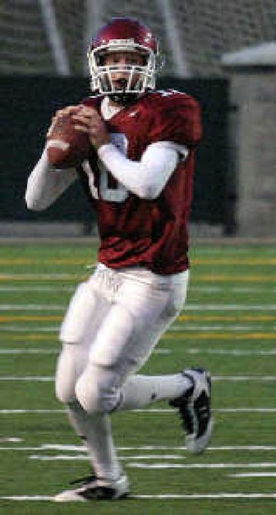 
North Central High senior quarterback Aaron Robinson looks for a pass. 
 (Todd Conley / The Spokesman-Review)