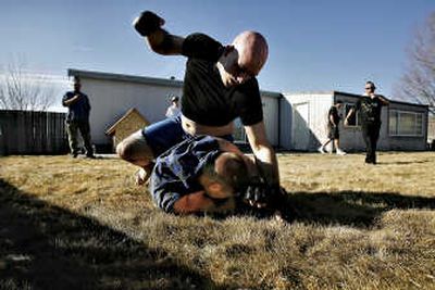 
Vengeance swings repeatedly for Nasty Rob's head during an organized fight in a Selah, Wash., backyard on  March 2. The fight will be posted to YouTube, where it will join about 22,000 videos of backyard and street fights from around the world. Associated Press
 (Associated Press / The Spokesman-Review)