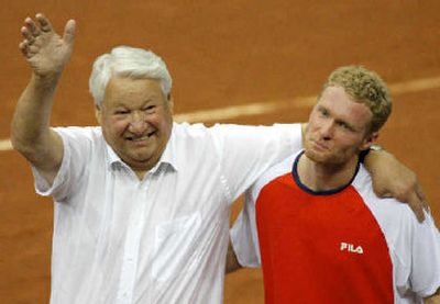 
Russia's former President Boris Yeltsin, left, and Dmitry Tursunov celebrate Tursunov's win over  Andy Roddick. 
 (Associated Press / The Spokesman-Review)