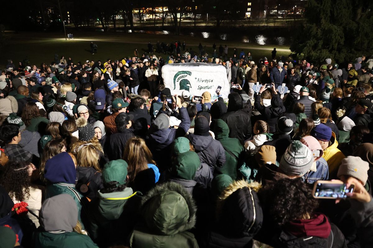 Students, faculty and others in the community attend a vigil on the campus of Michigan State University on Wednesday following Monday’s shooting in East Lansing, Mich.  (Scott Olson/Getty Images North America/TNS)