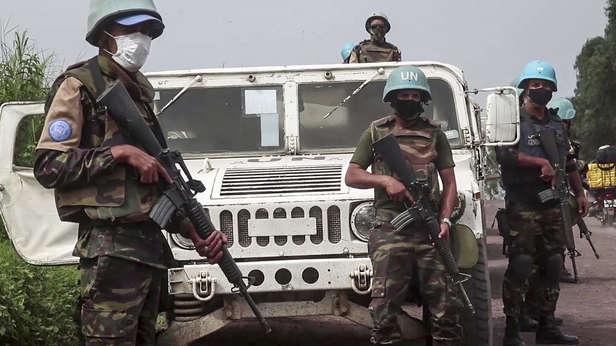 In this image taken from video, United Nations peacekeepers guard the area where a U.N. convoy was attacked and the Italian ambassador to Congo killed, in Nyiragongo, North Kivu province, Congo Monday, Feb. 22, 2021. The Italian ambassador to Congo Luca Attanasio, an Italian carabineri police officer and their Congolese driver were killed Monday in an attack on a U.N. convoy in an area that is home to myriad rebel groups, the Foreign Ministry and local people said.  (Justin Kabumba)