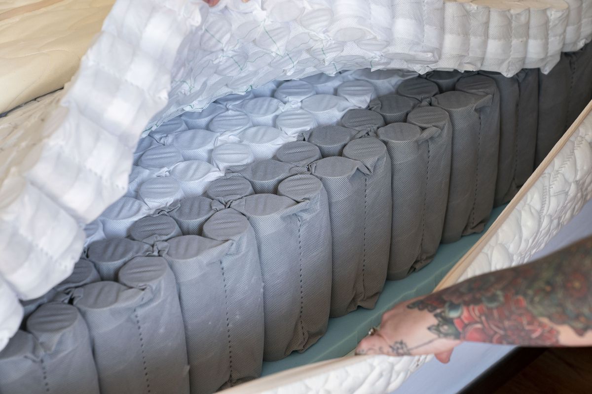 Jess Powell displays a layer of springs in a mattress she built. A lot of the time she spent on the project was devoted to researching her different options for the layers. Then, it was a matter of stacking those layers on top of one another and zipping them into an encasement. MUST CREDIT: David Ryder for The Washington Post  (David Ryder/For The Washington Post)