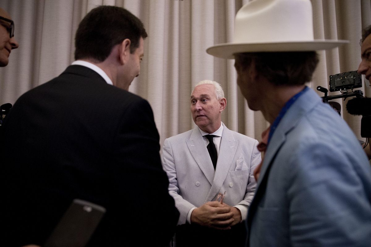 In this photo taken July 16, 2016, Roger Stone, an adviser to Donald Trump, center, speaks to reporters in New York. Stone now says he believes his contacts with a Russian-linked hacker who took credit for breaching the Democratic National Committee were obtained through a FISA warrant, which allows the government to collect the communications of individuals suspected of being agents of a foreign power. (Mary Altaffer / Associated Press)