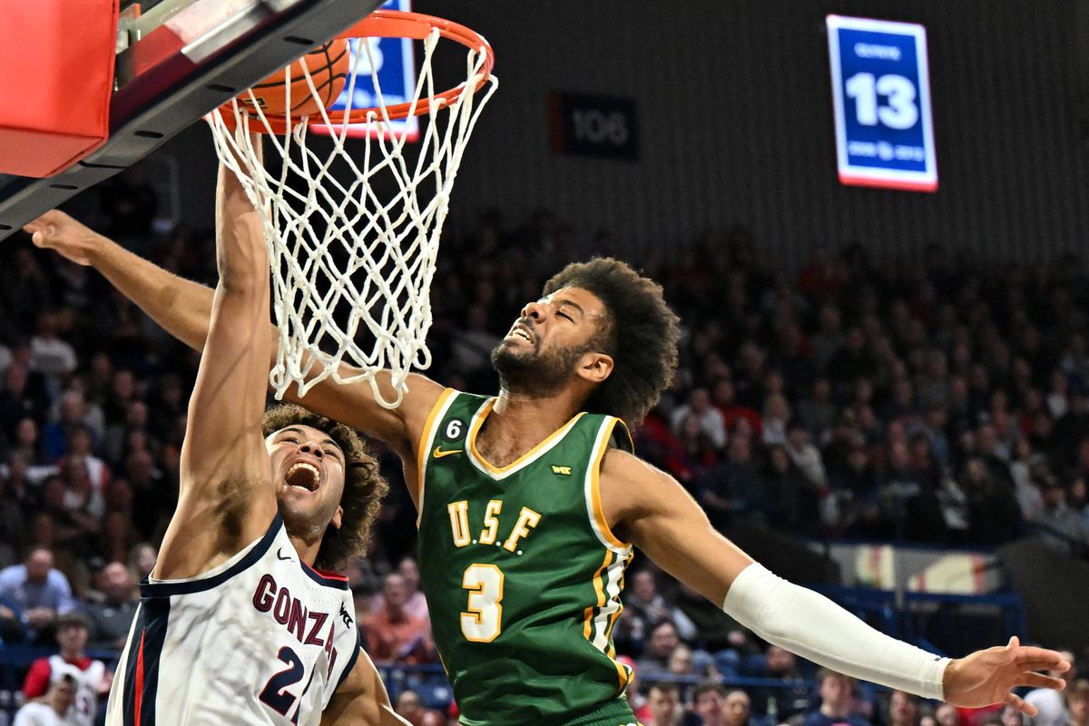 Gonzaga Bulldogs forward Anton Watson (22) dunks the ball against San Francisco Dons forward Isaiah Hawthorne (3) during the first half of a college basketball game on Thursday, Feb 2023, at McCarthey Athletic Center in Spokane, Wash.  (Tyler Tjomsland/The Spokesman-Review)