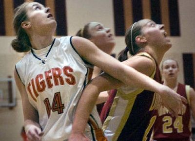 
U-Hi's Angie Bjorklund blocks out against Lewis and Clark's senior post Heather Bowman Thursday night at LC's Hunter Fieldhouse. 
 (Christopher Anderson / The Spokesman-Review)