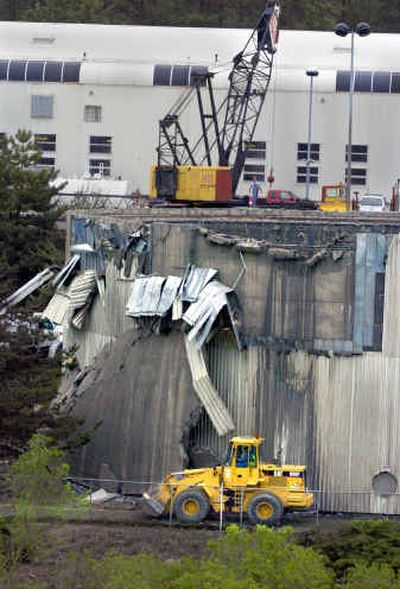 
Workers clean up sewage spilled when a 2-million-gallon tank at the Spokane Wastewater Treatment Plant ruptured on Monday. 
 (Christopher Anderson/ / The Spokesman-Review)