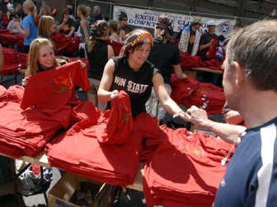 
Shadle Park softball players Jesica Berlinger and Jennifer Schwartz distribute T-shirts to finishers.
 (J. BART RAYNIAK / The Spokesman-Review)