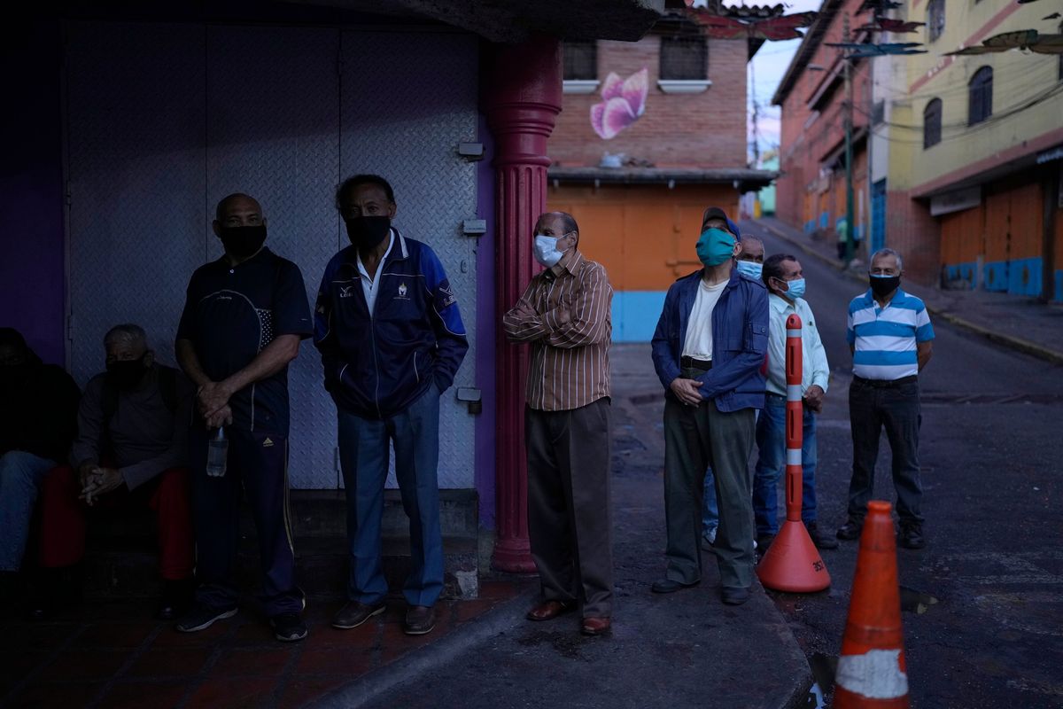 Venezuelans line up to vote during regional elections, at a polling station in Caracas, Venezuela, Sunday, Nov. 21, 2021. Venezuelans go to the polls to elect state governors and other local officials.  (Ariana Cubillos)