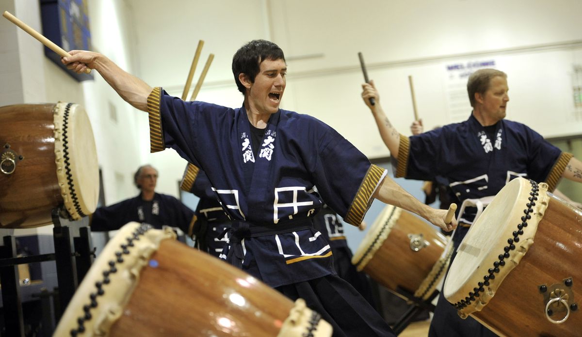 Aaron Mark, left, and Johnny Sarensen, of Spokane Taiko, perform traditional Japanese drumming for children Wednesday at the East Side Community Center. The group participated in the Spokane Public Library’s Summer Reading Program. (Dan Pelle)