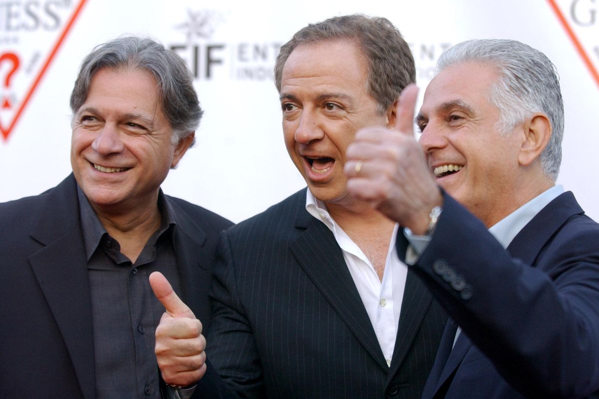 Guess founders and brothers, from left, Armand, Paul and Maurice Marciano pose together upon arriving at the Guess 20th Anniversary Party at the Wilshire Ebell Theater in Los Angeles, in May 2002. (CHRIS PIZZELLO / Associated Press)