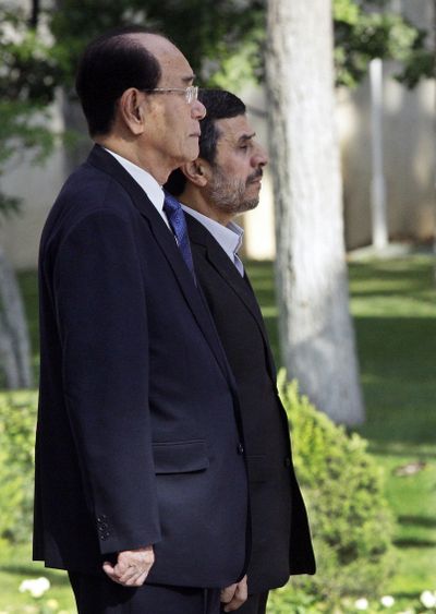 Iranian President Mahmoud Ahmadinejad, right, and president of the Presidium of North Korea's Supreme People's Assembly Kim Yong-nam, listen to their national anthems during an official welcoming ceremony in Tehran, Iran, Saturday, Sept. 1, 2012. (Vahid Salemi / Associated Press)