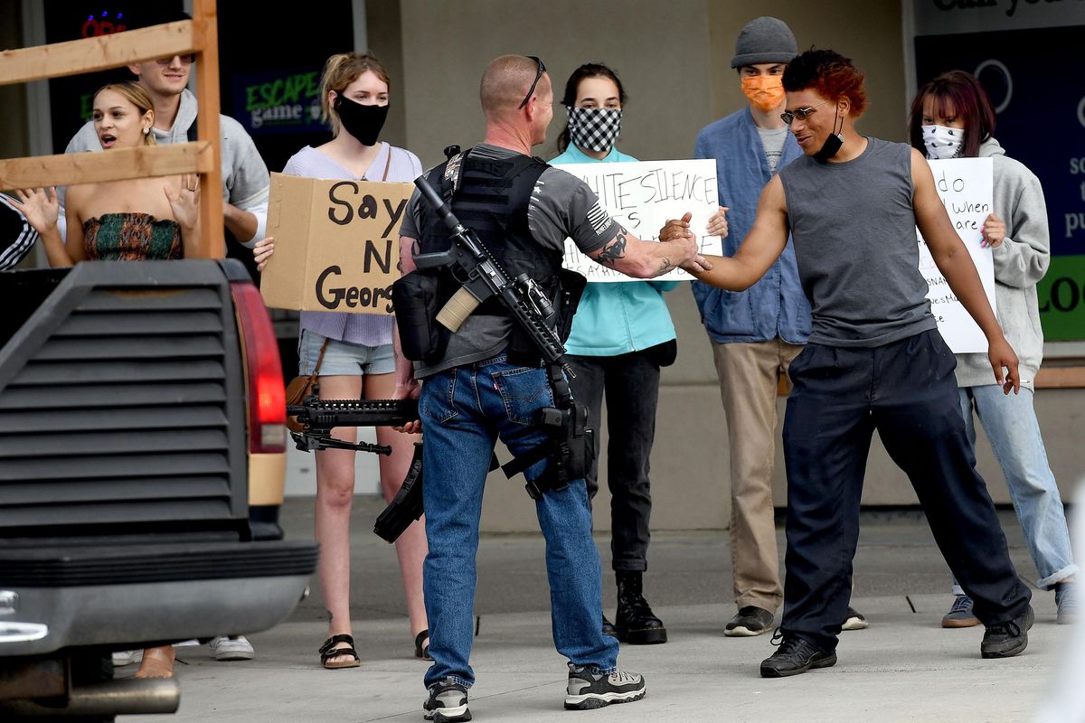 Demonstrators and armed citizens coexist peacefully in downtown Coeur  d'Alene | The Spokesman-Review