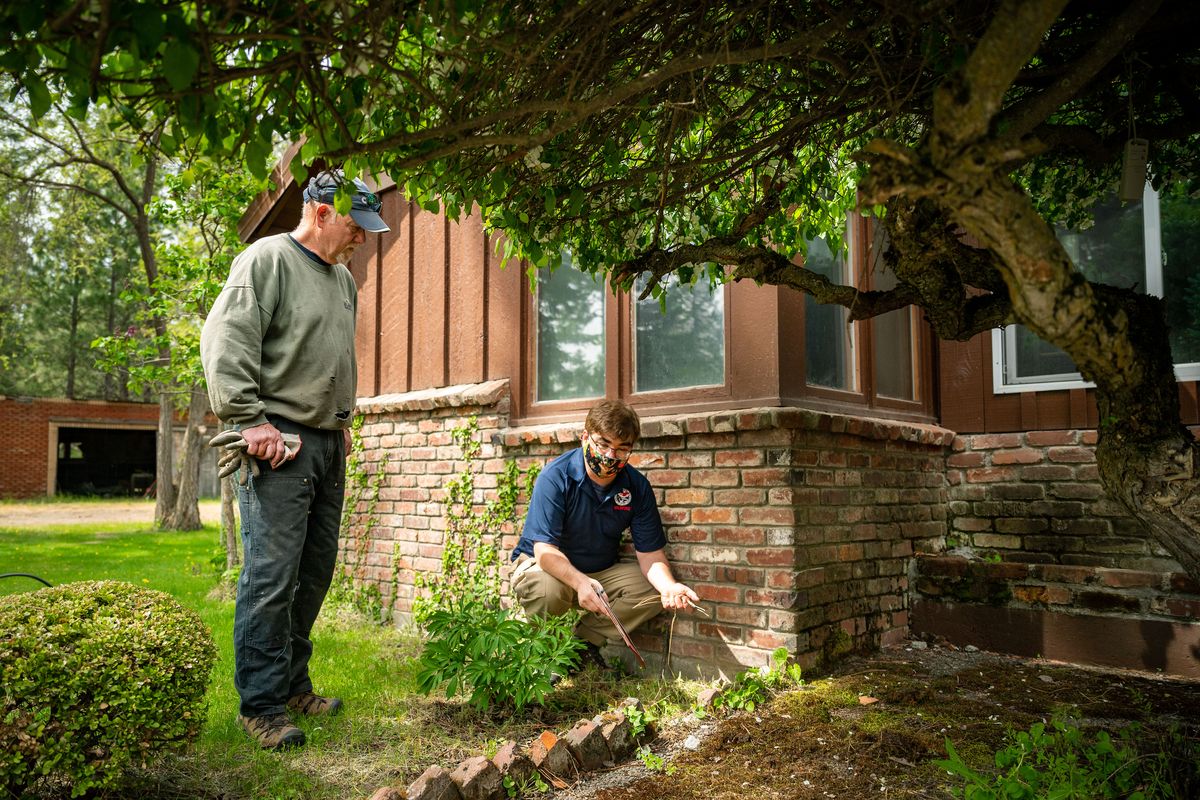 Guy Gifford, the Department of National Resources firewise and fire-adapted community coordinator, on right, performs a wildfire home risk assessment with homeowner Alan Berk, who lives in a forested area of Glenrose Prairie on Wednesday. New funding is being allocated to DNR for wildfire preparedness, which will include aiding homeowners to prepare their homes for fire season. Spokane is one of the first counties to pilot the program.  (COLIN MULVANY/THE SPOKESMAN-REVIEW)