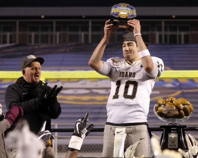 Idaho quarterback Matt Linehan (10) holds up the MVP trophy as head coach Paul Petrino, left, applauds after the Famous Idaho Potato Bowl NCAA college football game against Colorado State in Boise, Idaho, Thursday, Dec. 22, 2016. (Otto Kitsinger / Associated Press)