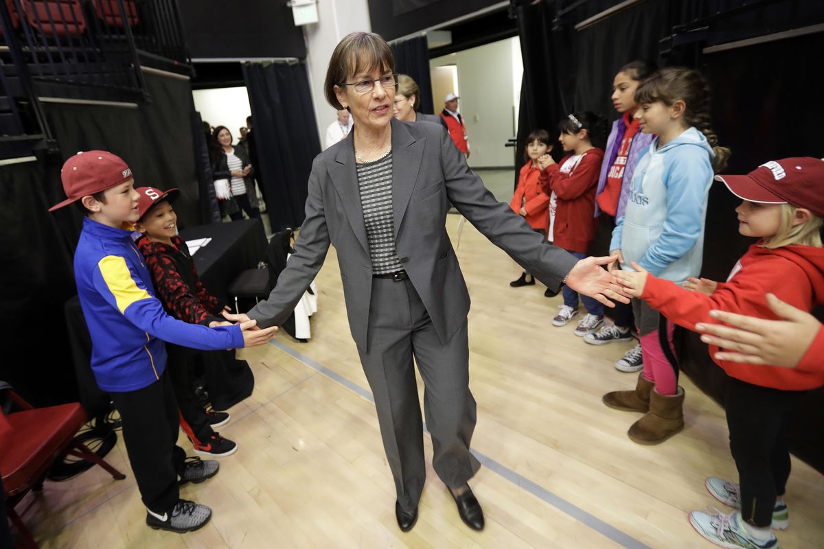 Stanford coach Tara VanDerveer is greeted by fans as she enters the court before the team