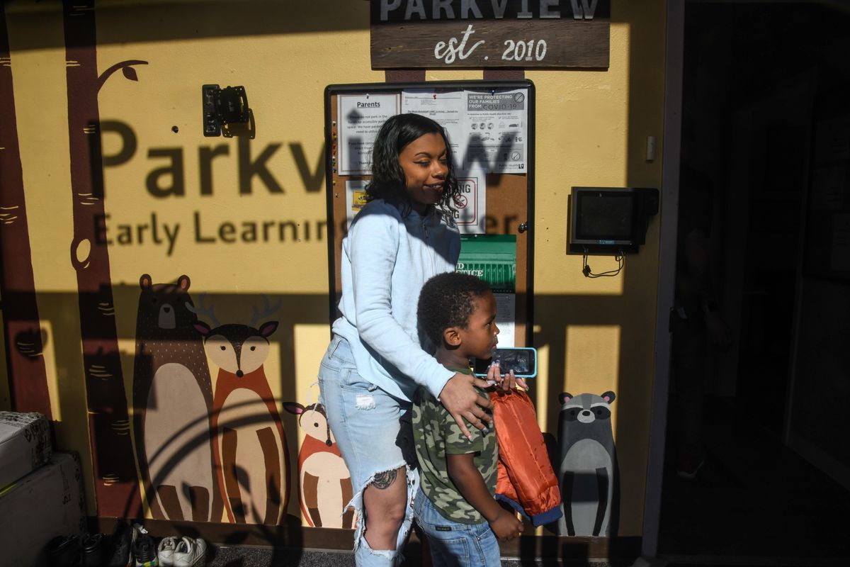 VaLeecia Bunten picks up her son, Ahmad, 4, from the Parkview Early Learning Center, Thursday, May 21, 2020, in Spokane, Wash. As businesses open back up, officials are worried there will be a lack of child care capacity. (Dan Pelle / The Spokesman-Review)