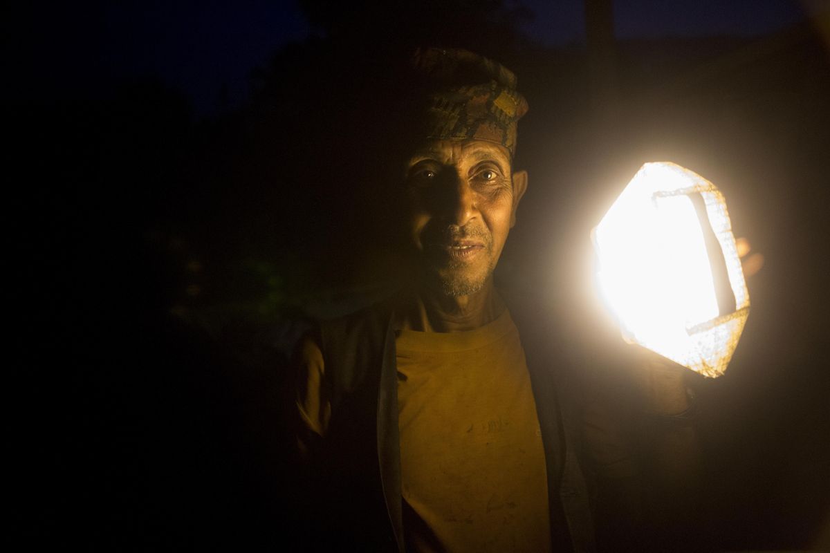 Gopal Karki shows off his Solarpuff, a collapsible solar powered light. The Conscious Connections Foundation, a Spokane nonprofit, provided these solar powered lights to several Nepalese villages following the 2015 earthquake. (Eli Francovich / The Spokesman-Review)