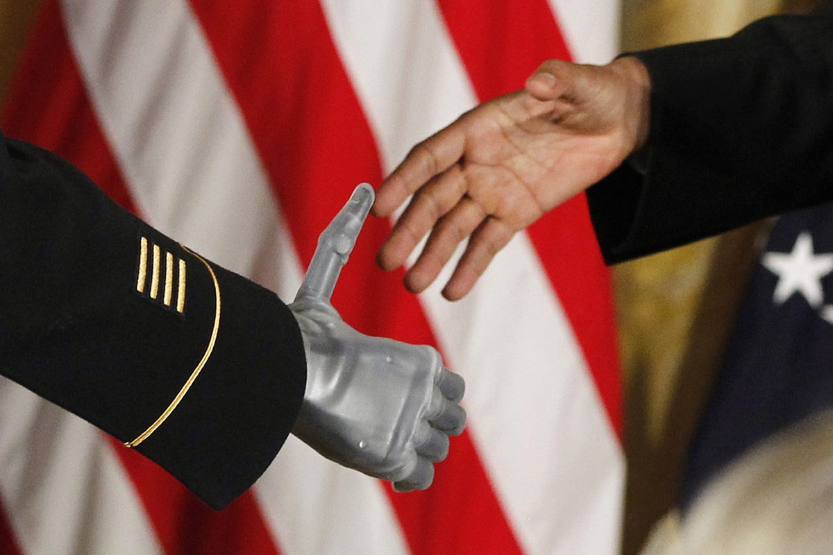 President Barack Obama shakes the prosthetic hand of Sgt. 1st Class Leroy Petry in the East Room of the White House Tuesday. (Associated Press)