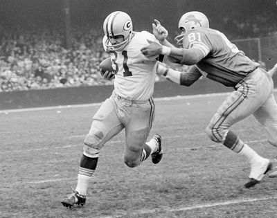 In this Nov. 22, 1962, file photo, Green Bay Packers fullback Jim Taylor (31) is brought down by Detroit Lions' Dick Lane in the third quarter of an NFL football game in Detroit. The Hall of Fame fullback died early Saturday, Oct. 13, 2018, the Packers announced. He was 83. (Preston Stroup / Associated Press)