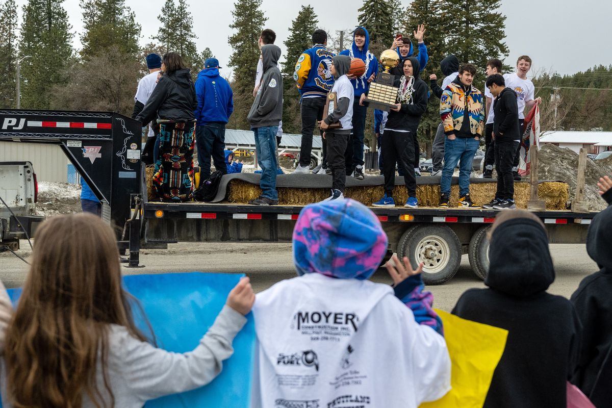 With trophy in hand, the Wellpinit High School basketball team celebrates their March 4 State B Championship win with a parade through town on Friday on the back of a flatbed trailer.  (COLIN MULVANY/THE SPOKESMAN-REVI)