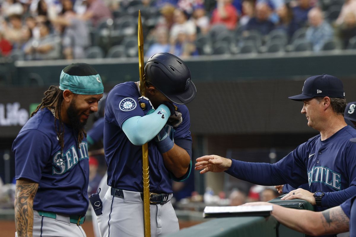Seattle Mariners center fielder Julio Rodriguez hugs the trident as he celebrates his two-run home run against the Texas Rangers on April 23. Rodriguez only has one home run in 38 games this season, after hitting 60 during his first two MLB seasons.  (Tribune News Service)