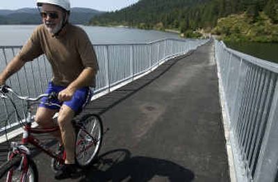 
Larry Mayer, who lives nearby, pumps his way up the ramp to the raised trestle over Lake Coeur d'Alene Thursday morning at Heyburn State Park. The trestle over Lake Coeur d'Alene is one of the highlights of the 72-mile Trail of the Coeur d'Alenes rails to trails project. 
 (Jesse Tinsley/The Spokesman-Revi / The Spokesman-Review)