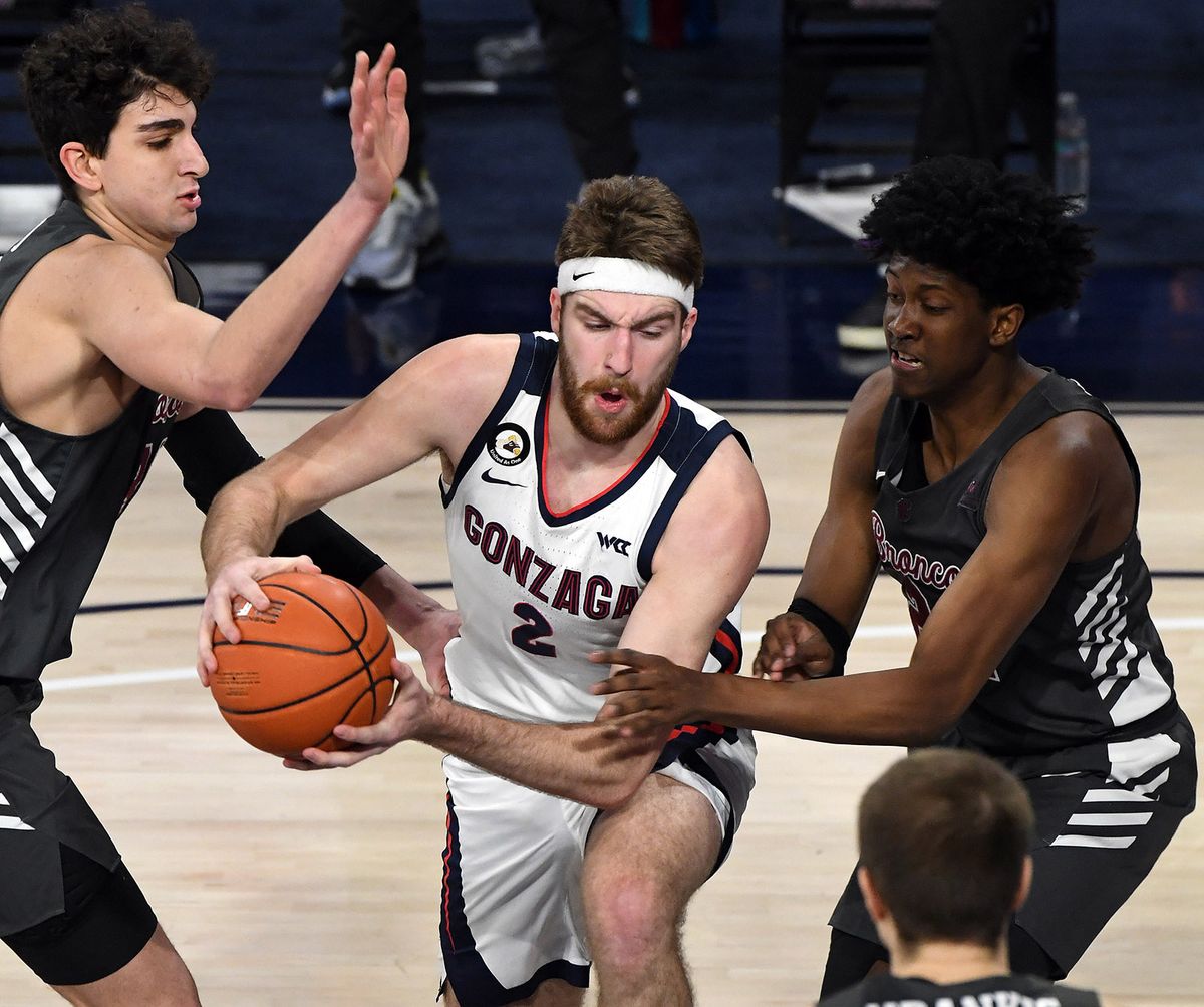 Gonzaga forward Drew Timme (2) drives the ball into the key as Santa Clara forward Guglielmo Caruso (on left) and Santa Clara guard Jalen Williams (on right) defend during the first half of a college basketball game, Thursday, Feb. 25, 2021, in the McCarthey Athletic Center.  (Colin Mulvany/THE SPOKESMAN-REVIEW)