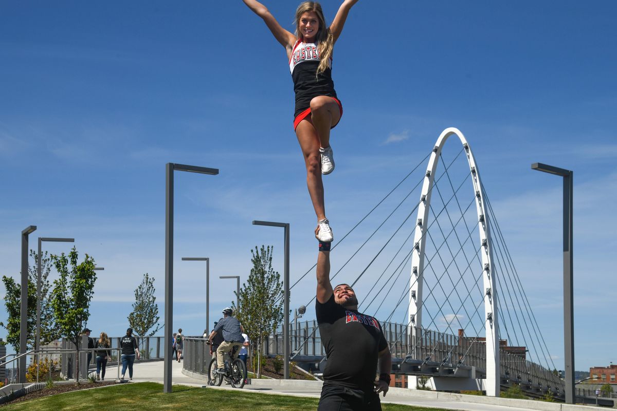 Eastern Washington University cheerleaders Kenzie Briggs and David “Walnut” Valdovinos strike a Liberty Pose as they participated in the entertainment during the official opening of the University Gateway Bridge, Tuesday, May 7, 2019, in Spokane. (Dan Pelle / The Spokesman-Review)