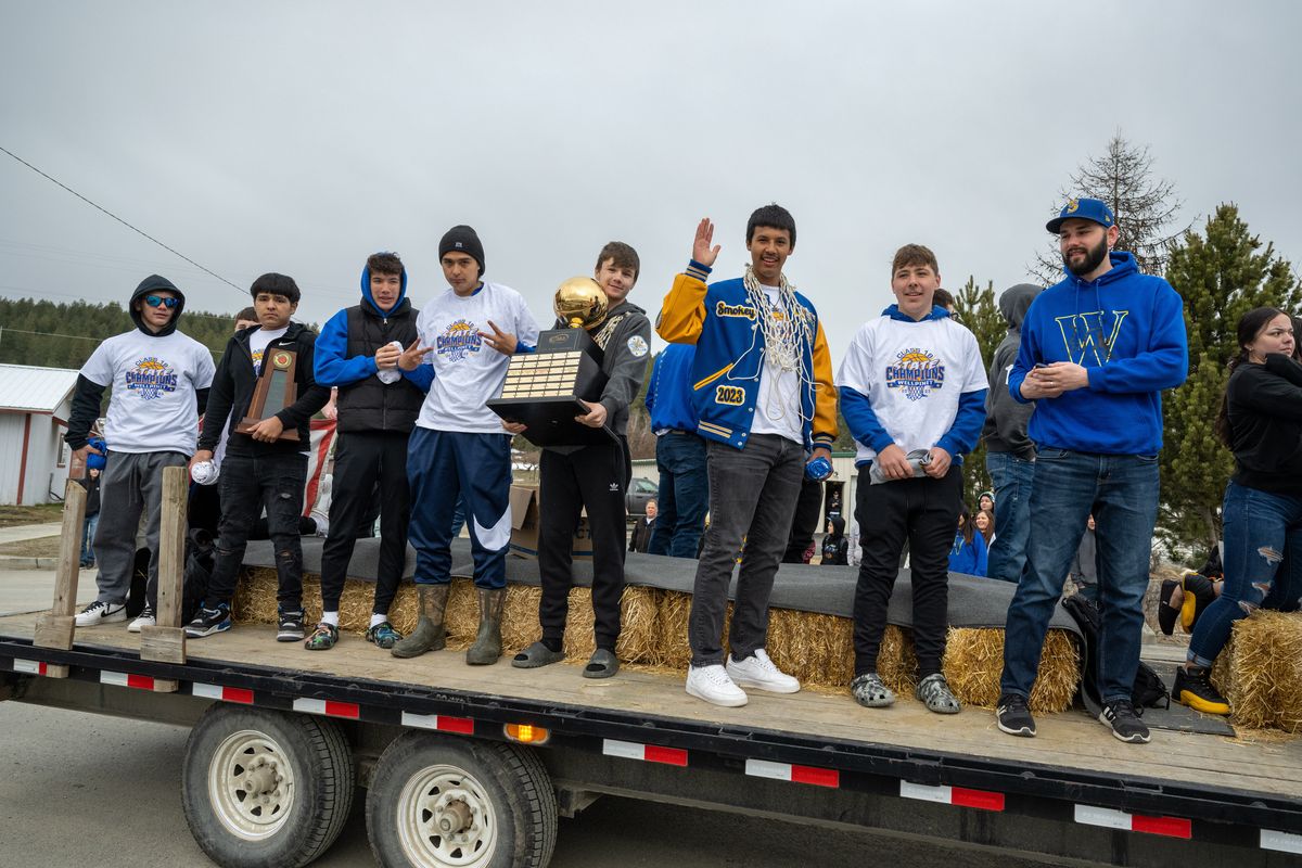 With trophy in hand, the Wellpinit High School basketball team celebrates their March 4th State B Championship win with a parade through town on the back of a flatbed trailer, Friday, March 24, 2023.  (COLIN MULVANY/THE SPOKESMAN-REVI)