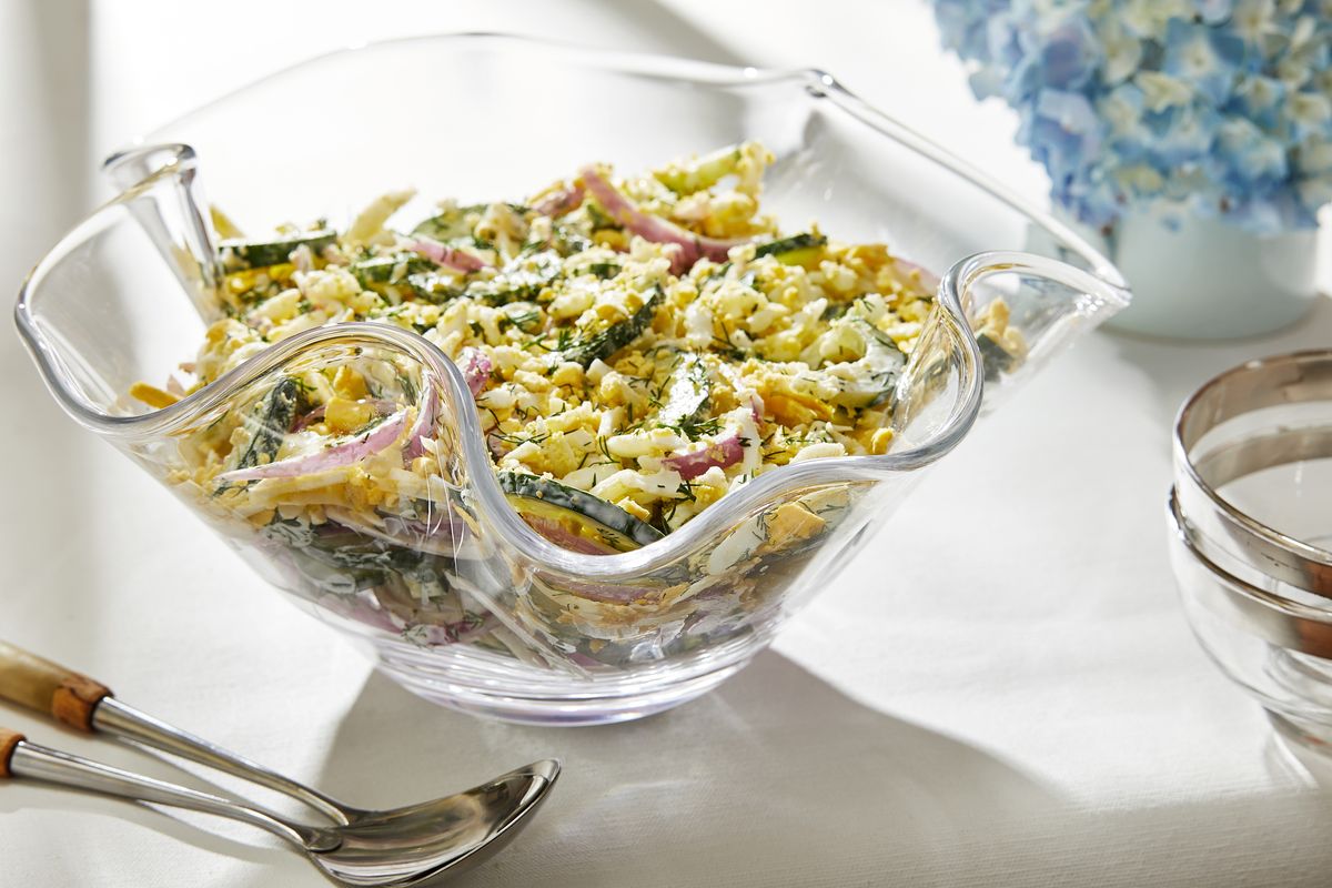 This summery cucumber salad, fragrant with dill and tossed in a creamy yogurt dressing, gets panache and protein from a fluffy, yellow grated egg mimosa topping. (Tom McCorkle/For the Washington Post)