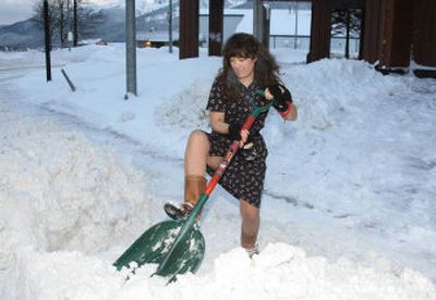
Wendy Marriott, manager of the Juneau Centennial Hall Convention Center, shovels a snow-and-ice berm from in front of the hall recently in Juneau, Alaska. Marriott, a lifelong Juneau resident, did not mind shoveling the snow in the 25-degree weather, as she prepared for the annual public market there. 
 (AP/The Empire, Brian Wallace / The Spokesman-Review)
