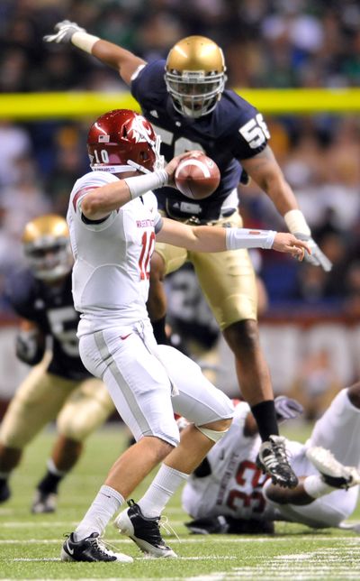 WSU’s Jeff Tuel is pressured into an incomplete pass by Notre Dame’s Brian Smith.  (Associated Press / The Spokesman-Review)